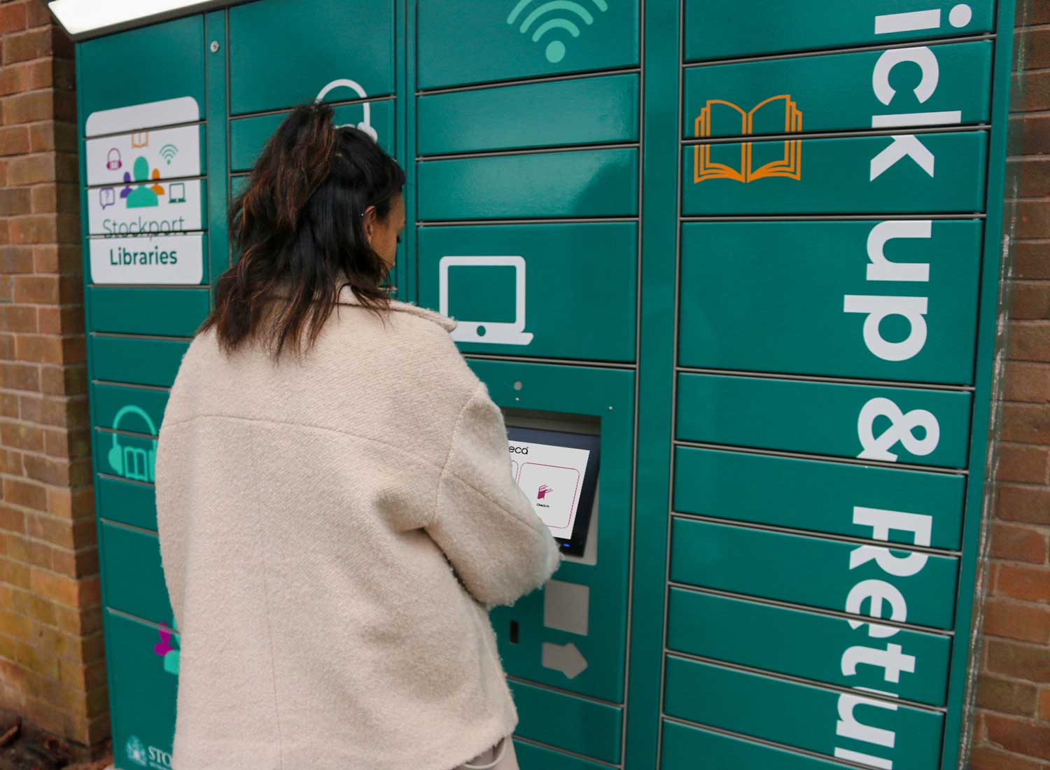 User picking up a book at Marple library at the remoteLocker outdoor